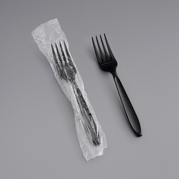A Solo Impress black plastic fork in a plastic wrapper.