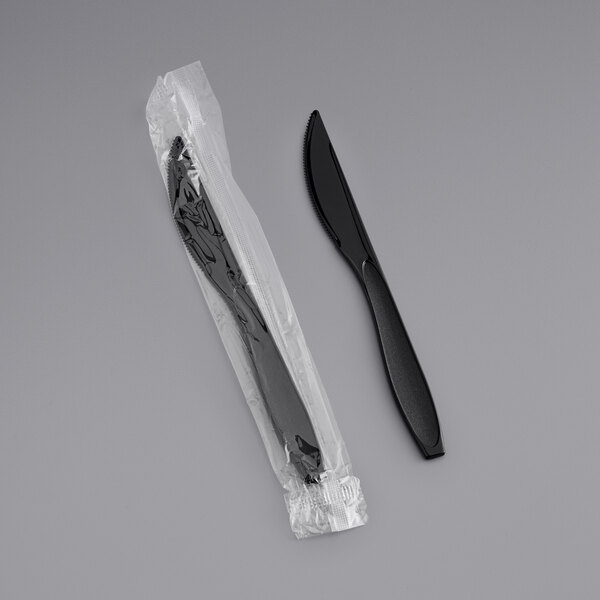 A Solo Impress heavy weight black plastic knife in plastic wrap.