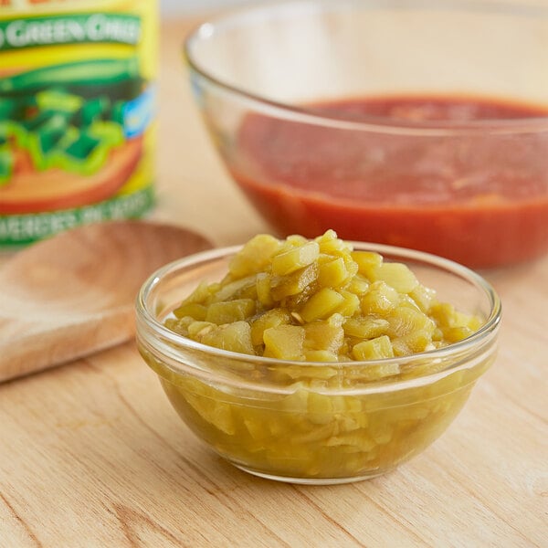 A bowl of Las Palmas diced green chiles next to a bowl of red sauce.