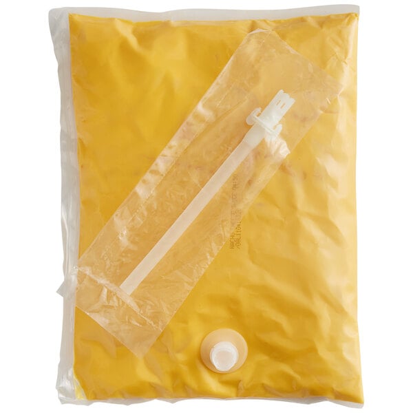 A yellow plastic bag of Ortega Nacho Cheese Sauce with a white plastic tube inside.