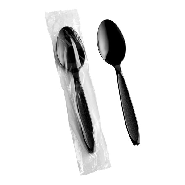 A heavy weight black plastic teaspoon, with one shown individually wrapped in plastic packaging.