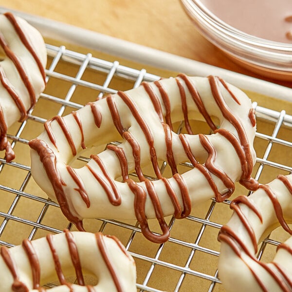 A pretzel with Alpine milk chocolate drizzled on it.