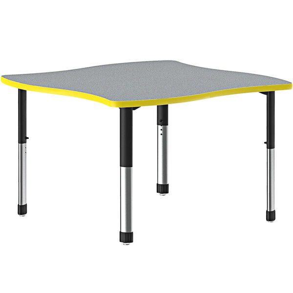 A gray rectangular Correll collaborative desk with a yellow band on black legs.