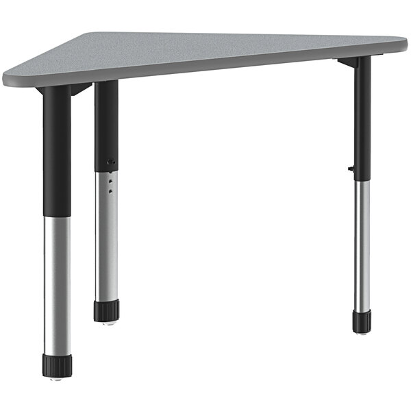 A grey and black triangular Correll collaborative desk with black legs.