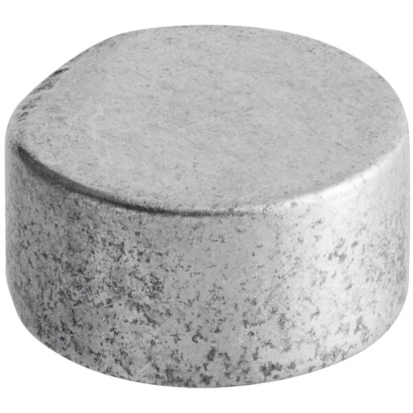 A round grey metal cap with specks on a white background.