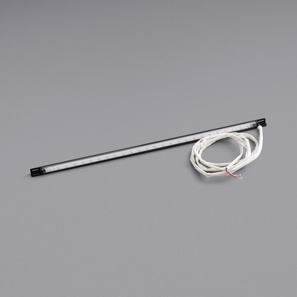 A white light bar with a wire attached to it.