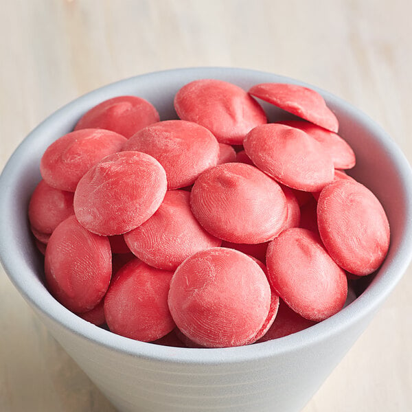 small bowl filled with red candy coating wafers