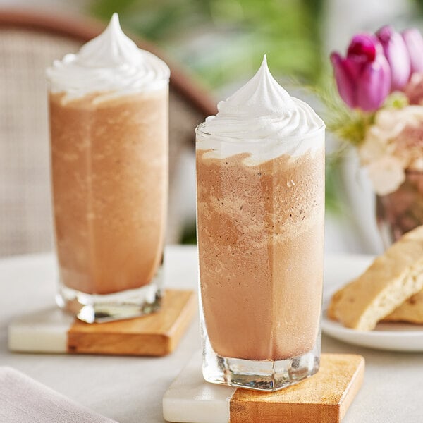Two glasses of DaVinci Gourmet Mocha Cappuccino with whipped cream on top.