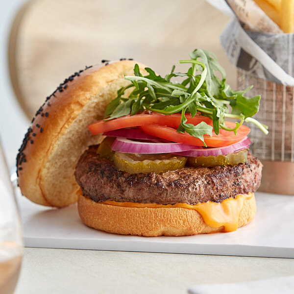 A TenderBison burger with lettuce, tomato, onion, and cheese.