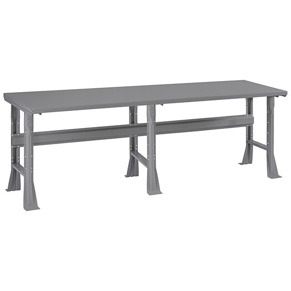 A grey rectangular table with flared legs and a steel top.