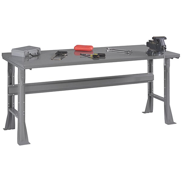 A grey work table with tools on it.