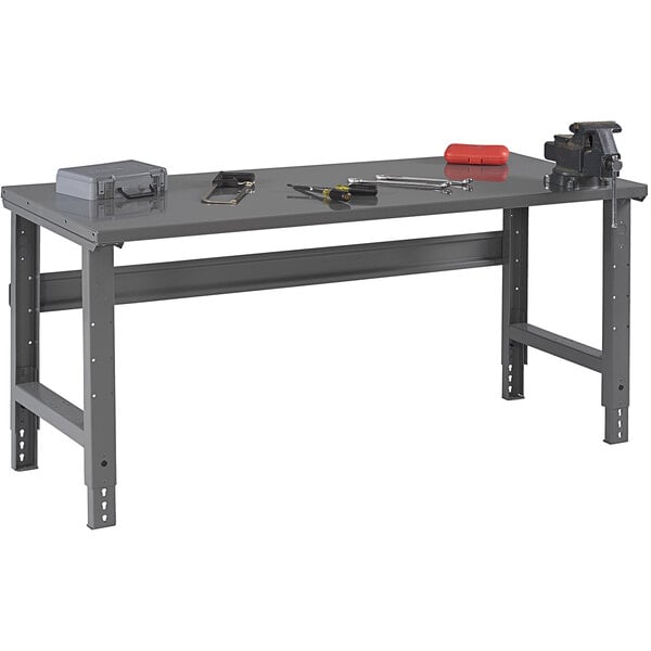 A grey Tennsco steel workbench with tools on it.