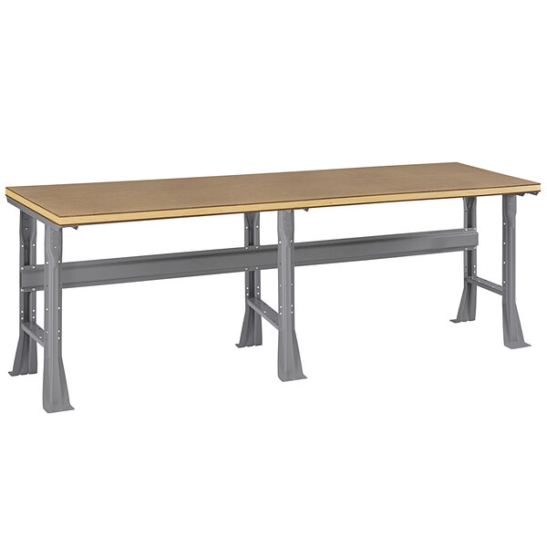 A Tennsco workbench with a long rectangular compressed wood top and metal legs.