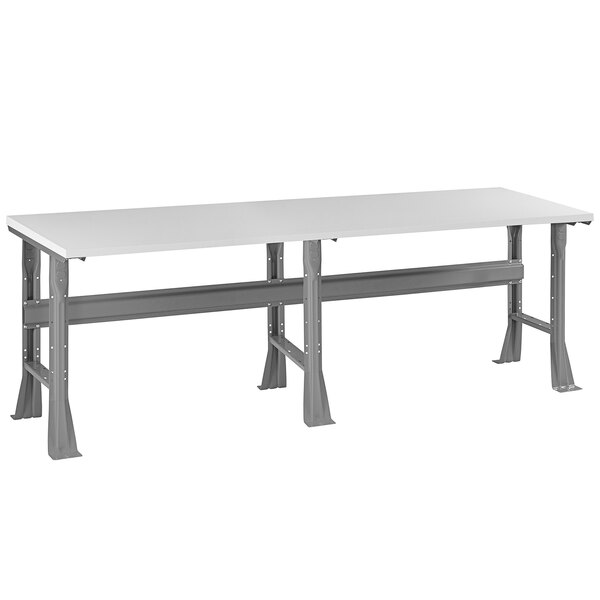 A white rectangular Tennsco plastic laminate workbench with metal legs.