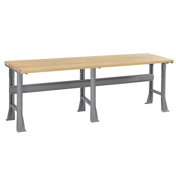 A Tennsco workbench with a hardwood top and flared steel legs.