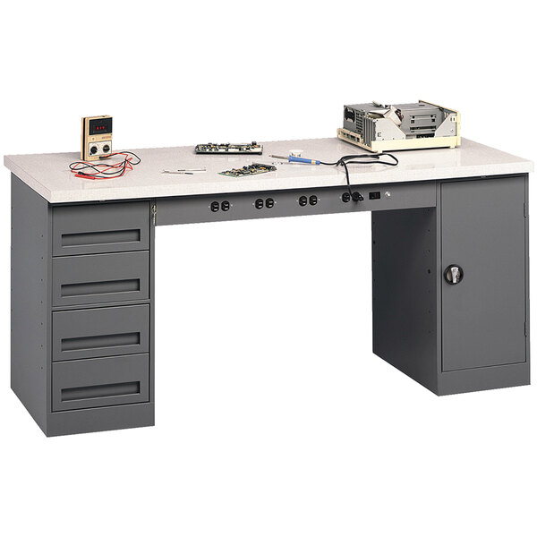 A grey Tennsco plastic laminate workbench with a white counter top, cabinet, and drawers.