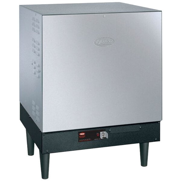 A silver Hatco booster water heater with black legs.