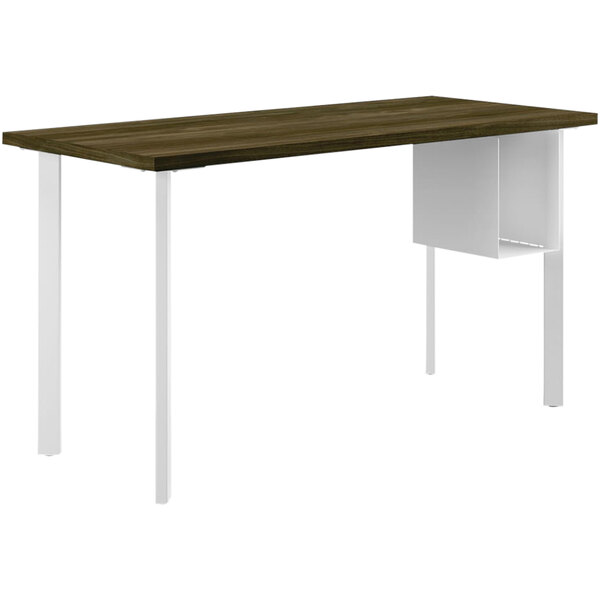 A brown HON Coze desk with white legs and a white U-shaped shelf inside.