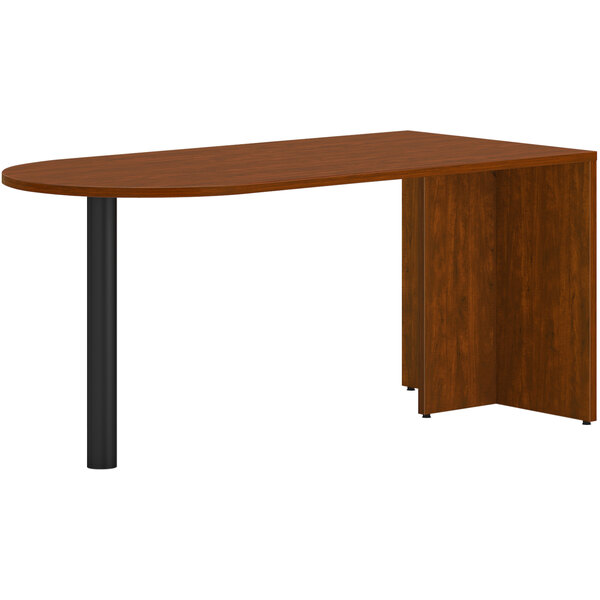A brown HON Mod Peninsula desk with black legs.