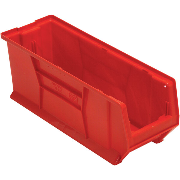 A red plastic Quantum storage bin with a handle.