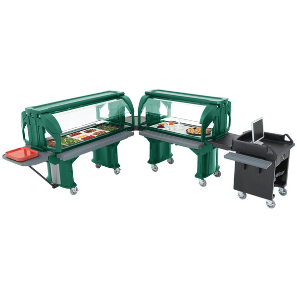 Two green Cambro Versa food carts with food on them.