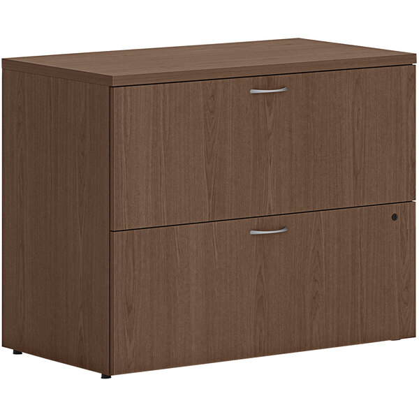 A HON sepia walnut lateral file cabinet with two drawers.