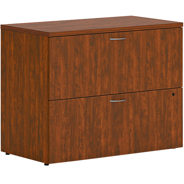 A brown wooden HON lateral file cabinet with two drawers.