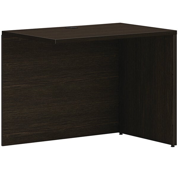 A dark brown HON Mod desk return shell.