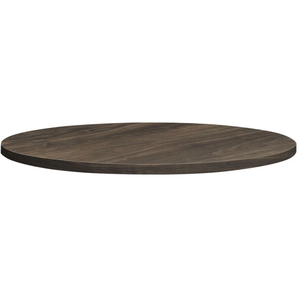 A HON round wooden table top with a dark brown finish.