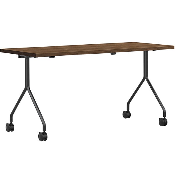 A HON Pinnacle rectangular table with black wheels.