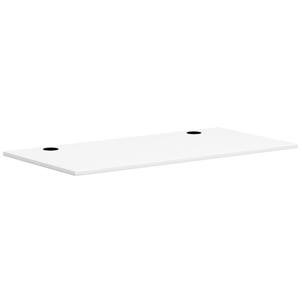 A white rectangular HON worksurface with two black holes.