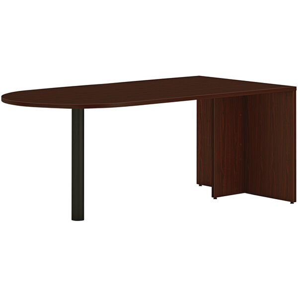 A traditional mahogany HON peninsula desk with black end panel legs.