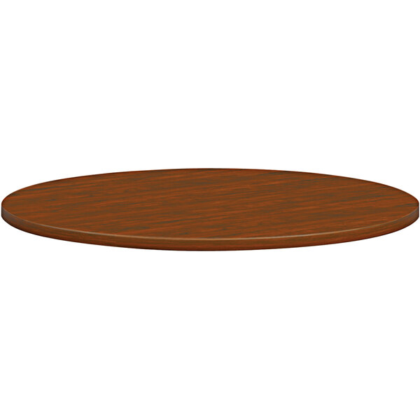 A round russet cherry wood conference table top.
