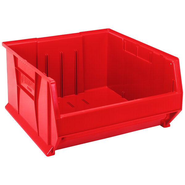 A Quantum red plastic bin with black handles.