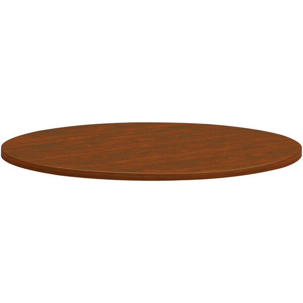 A brown circular HON conference table top.
