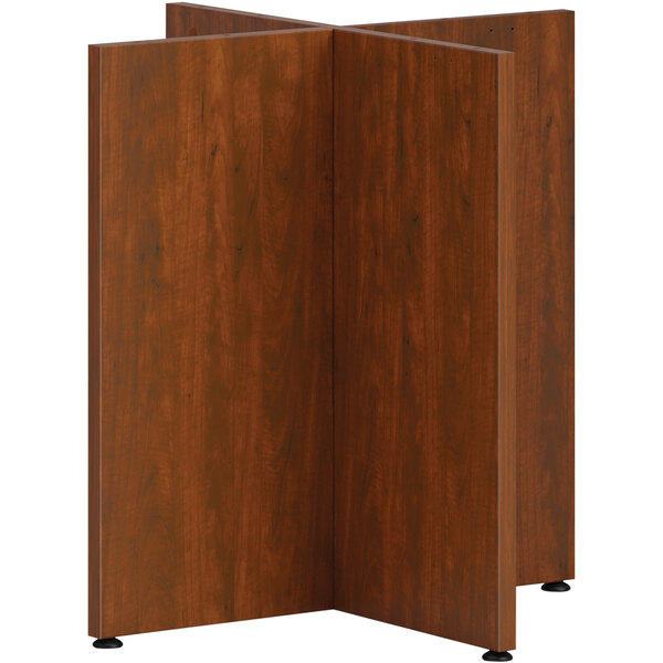 A wood paneled X-base for a conference table.