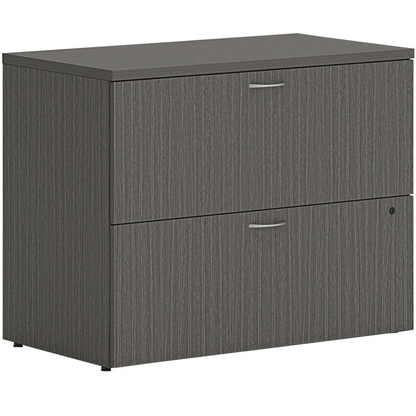 A slate grey HON lateral file cabinet with two drawers.