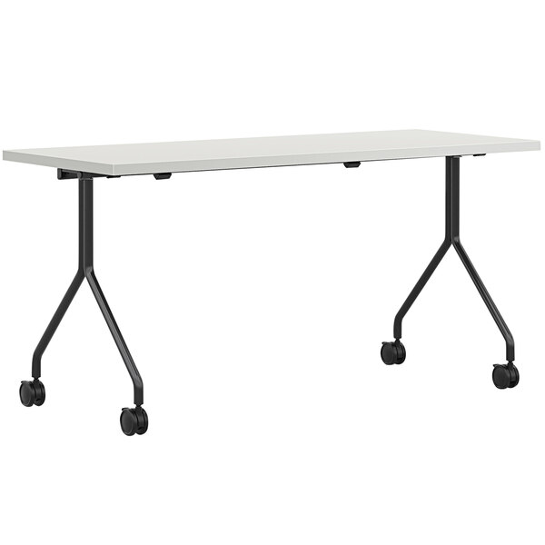 A silver mesh rectangular HON nesting table on wheels.