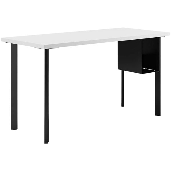 A white rectangular HON desk with black legs and a U-storage shelf.