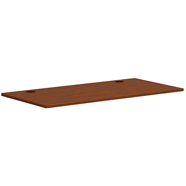 A brown rectangular HON worksurface with black edges.