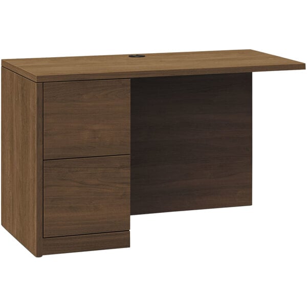A wooden desk with a left return and 2 file drawers.