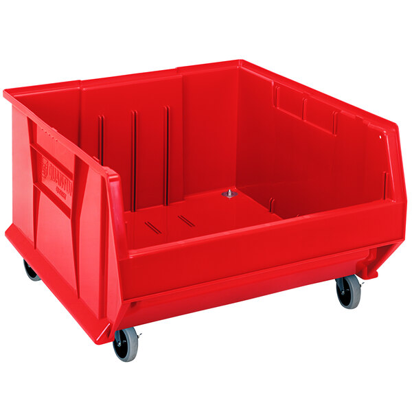 A Quantum red plastic storage bin with wheels.