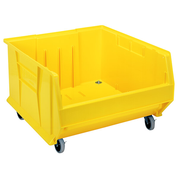 A Quantum yellow plastic storage bin with wheels.