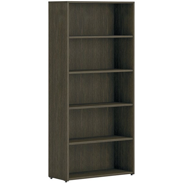 A brown HON bookcase with five shelves.