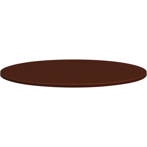 A close-up of a brown HON Mod conference table top with a circular shape.