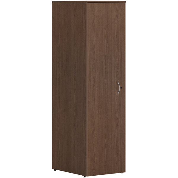 A sepia walnut laminate HON wardrobe cabinet with a silver handle.
