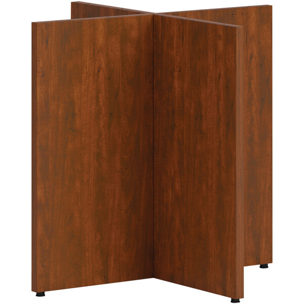 A HON Russet Cherry laminate X-base for a wood paneled table.
