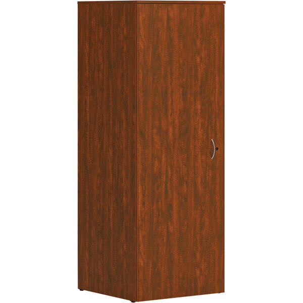A russet cherry wooden cabinet with a door.
