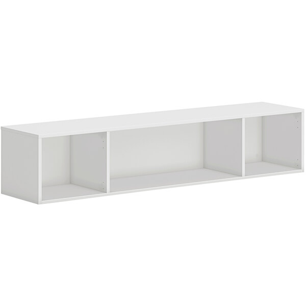 A white wall mounted open storage cabinet with shelves inside.