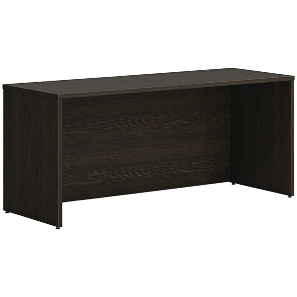 A dark brown desk with a dark wood top.